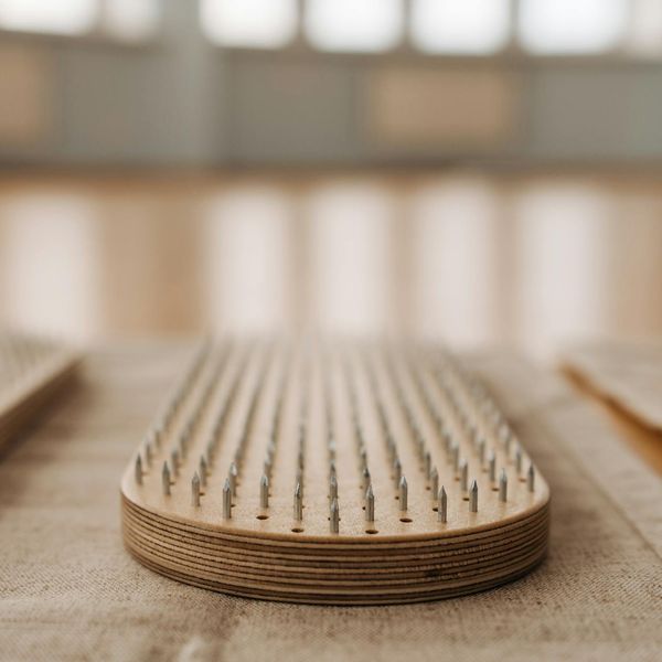 Close-up of a textured yoga mat on a wooden floor.